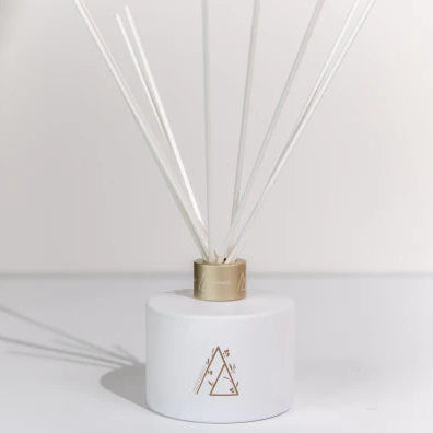 White diffuser with wooden cap on a white background